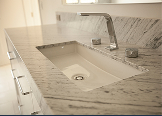 An undermount sink with chrome plumbing fixtures
